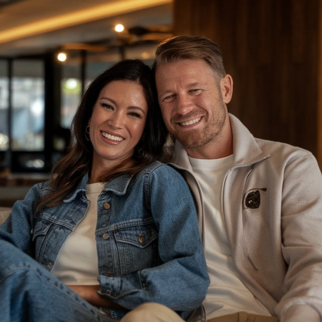 Man and woman sitting together on a couch in a modern indoor setting
